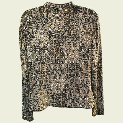 Elegant black jacket with gold and silver embellishments on a light beige background