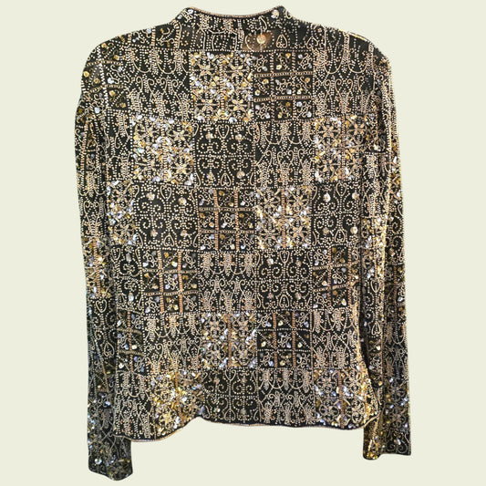 Elegant black jacket with gold and silver embellishments on a light beige background