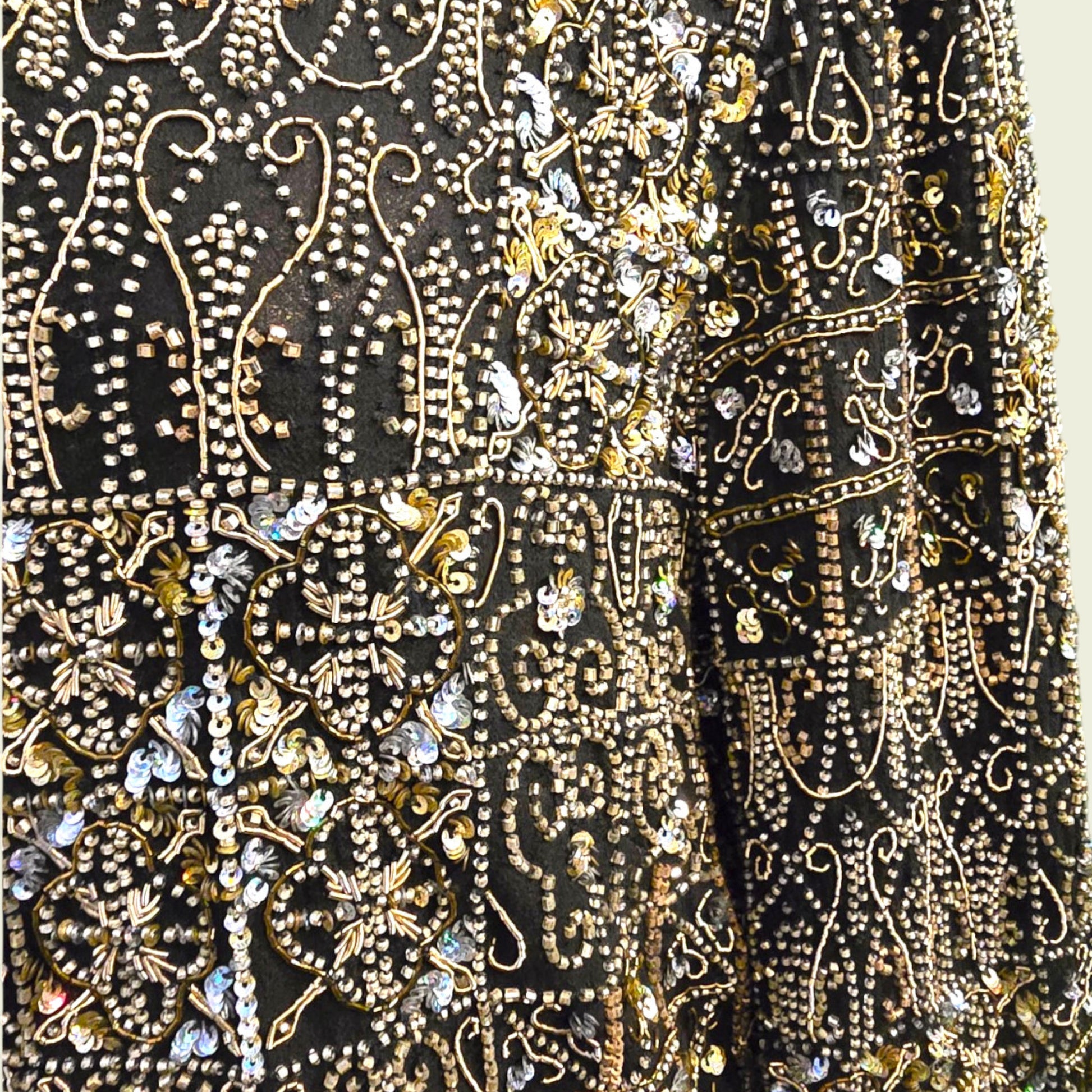 Close-up of a black fabric with gold and silver embroidery