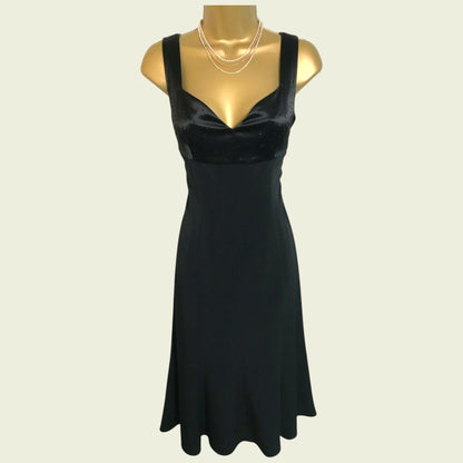 Black dress on a mannequin against a beige background