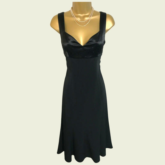 Black dress on a mannequin against a beige background