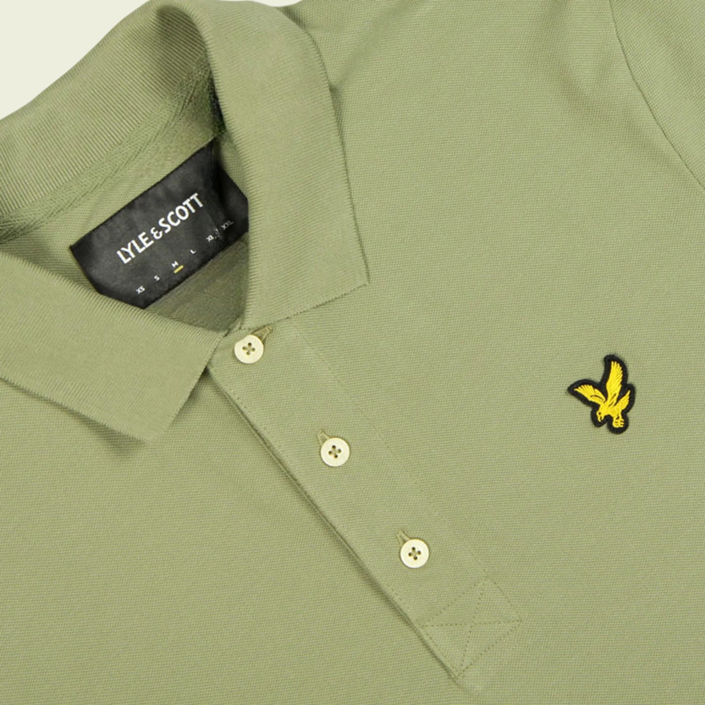 Green polo shirt with Lyle & Scott logo on collar and chest pocket.