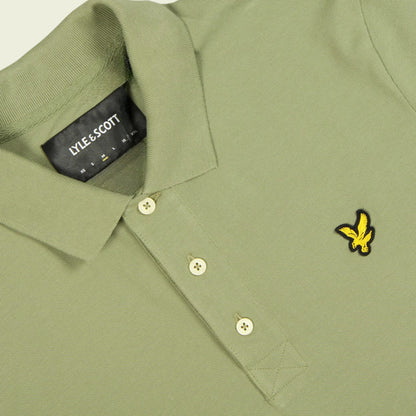 Green polo shirt with Lyle & Scott logo on collar and chest pocket.