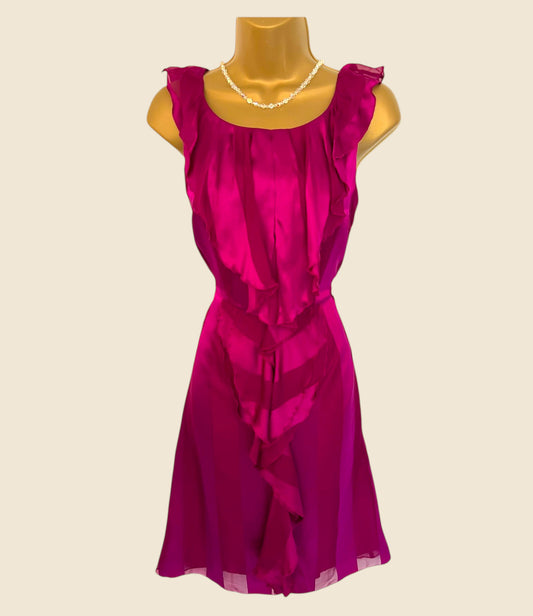 Fuchsia dress on a mannequin against a beige background