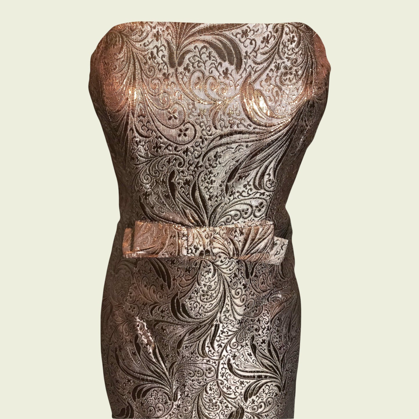 Decorative strapless dress with intricate patterns on a beige background