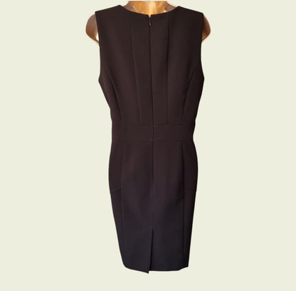 Black sleeveless dress on a beige background