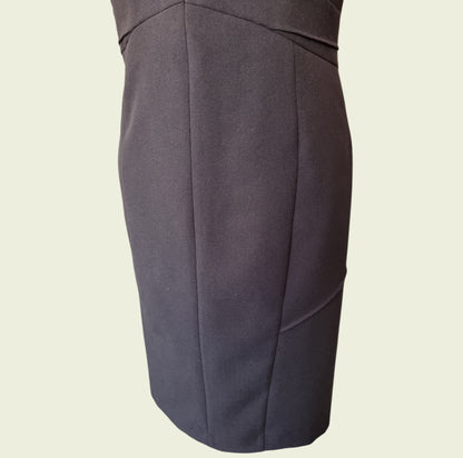 Black pencil dress on a beige background