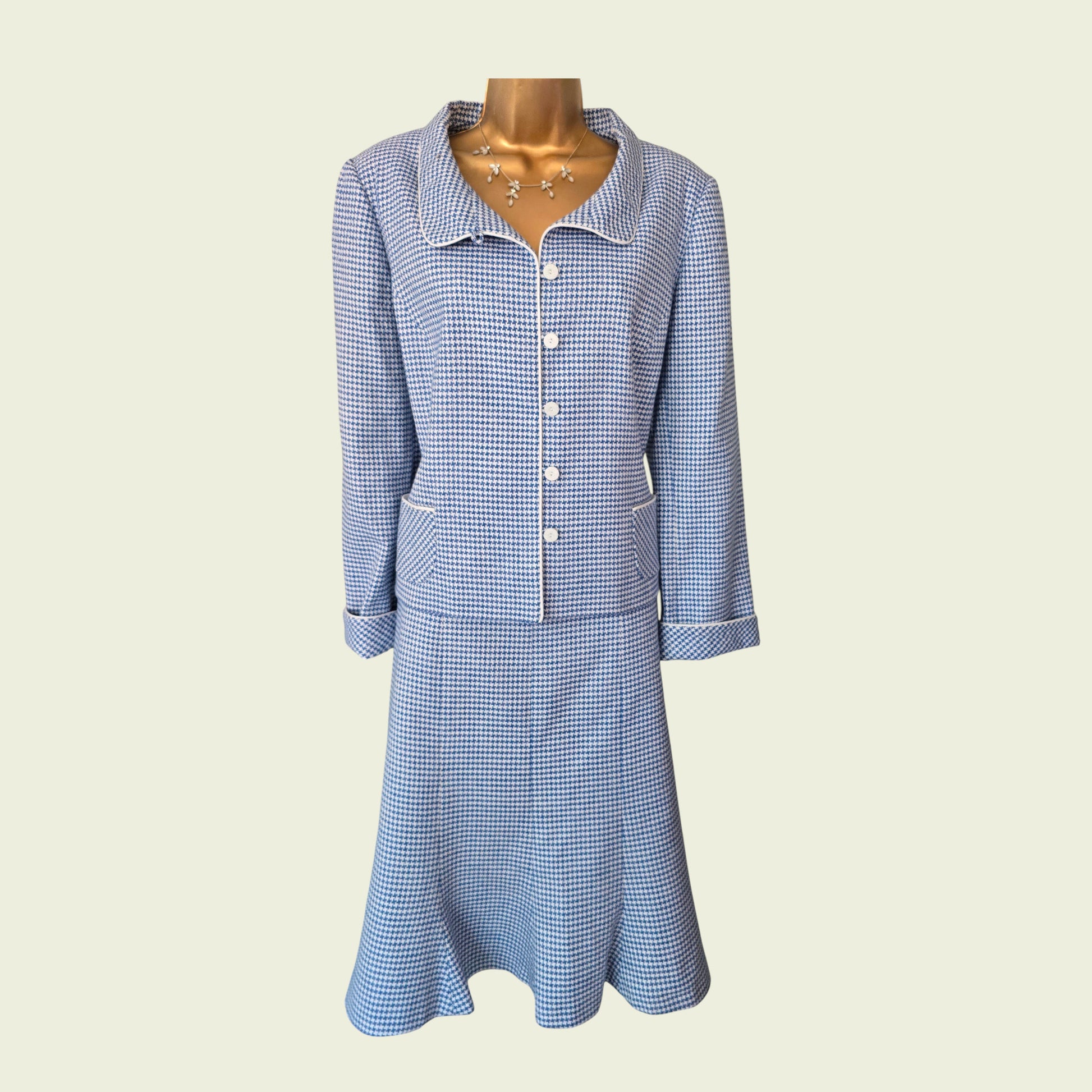 Blue checkered suit on a mannequin against a beige background