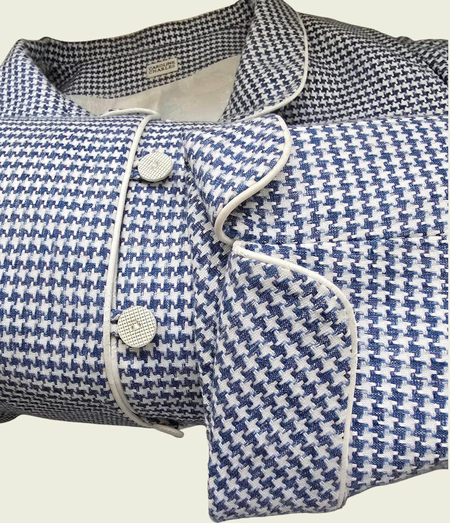 Blue and white houndstooth patterned jacket on a light background