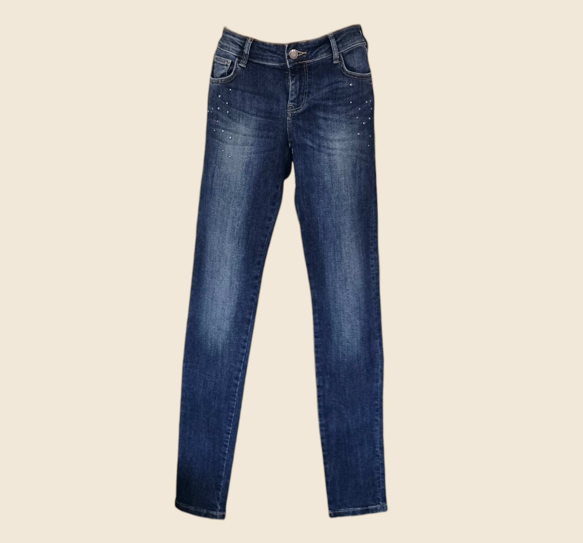 Pair of blue jeans on a beige background