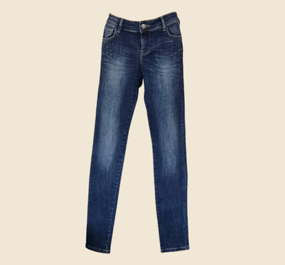 Pair of blue jeans on a beige background