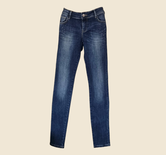 Pair of blue jeans on a beige background