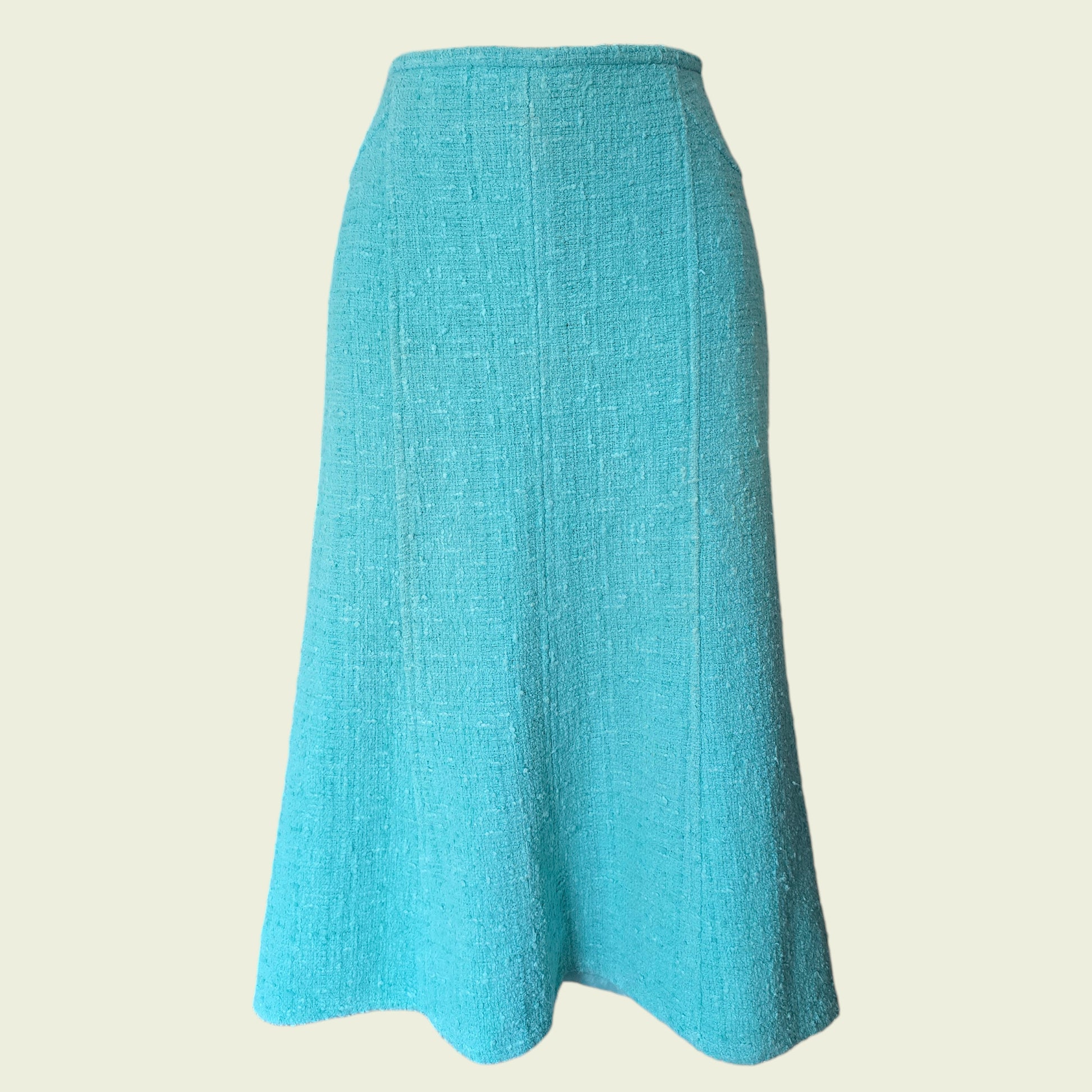 Turquoise skirt on a beige background