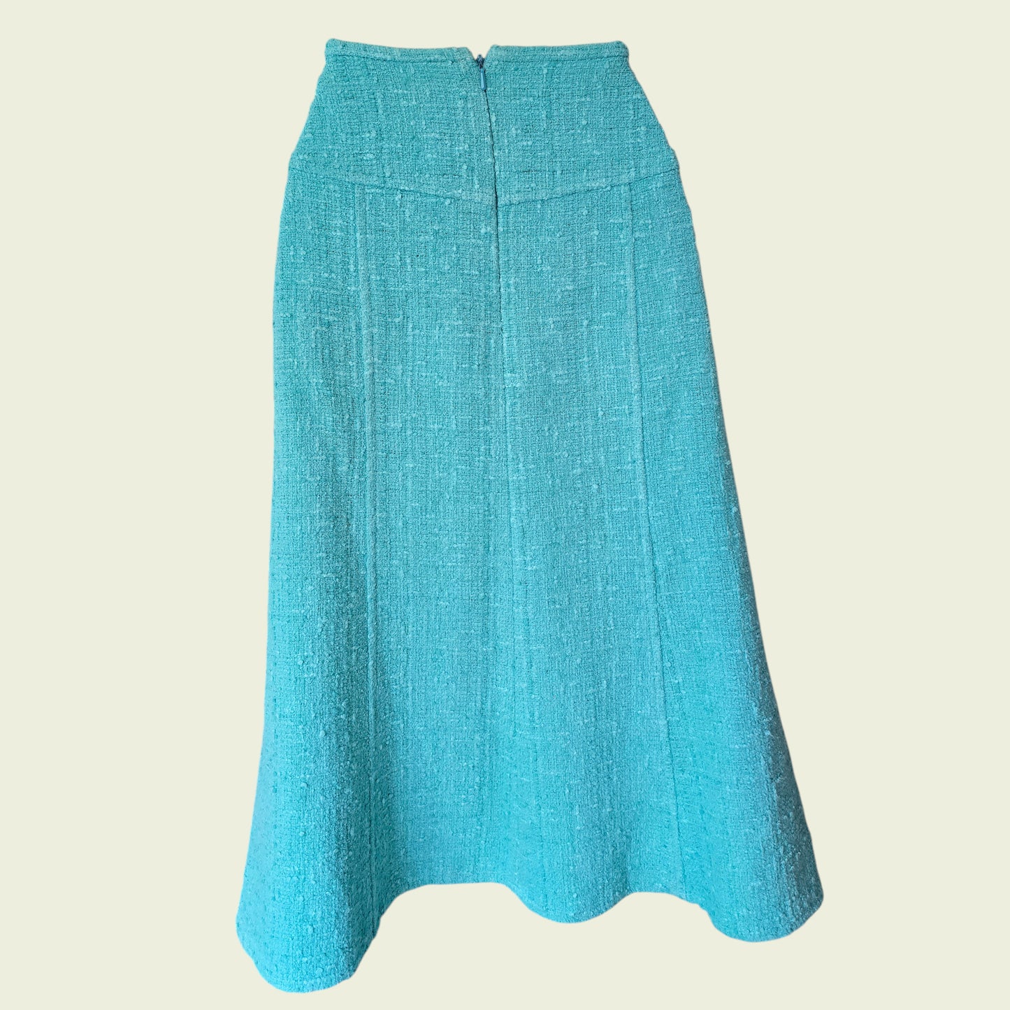 Turquoise skirt on a beige background