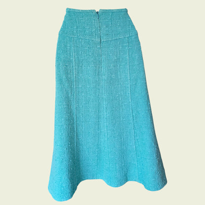 Turquoise skirt on a beige background