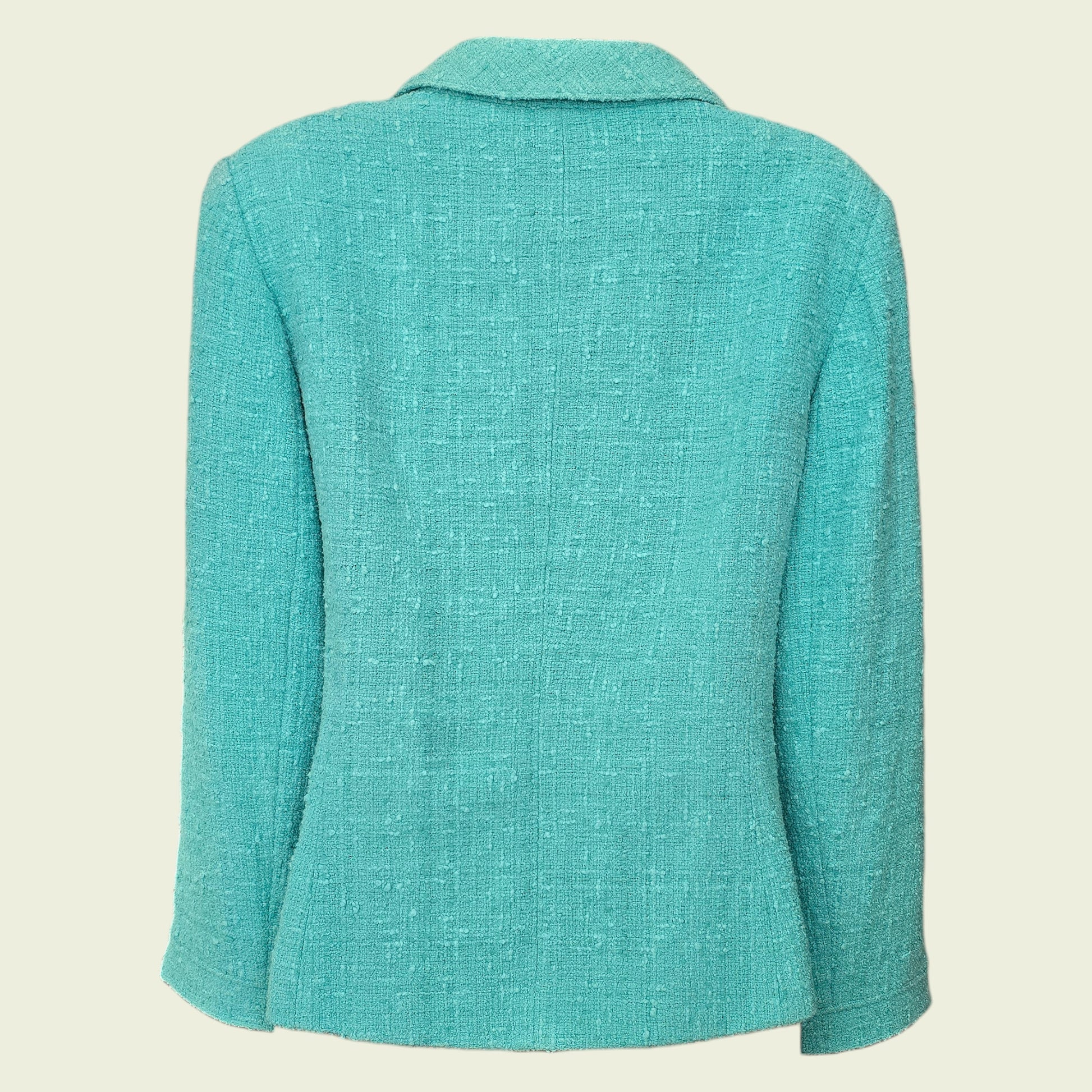 Turquoise blazer on a beige background