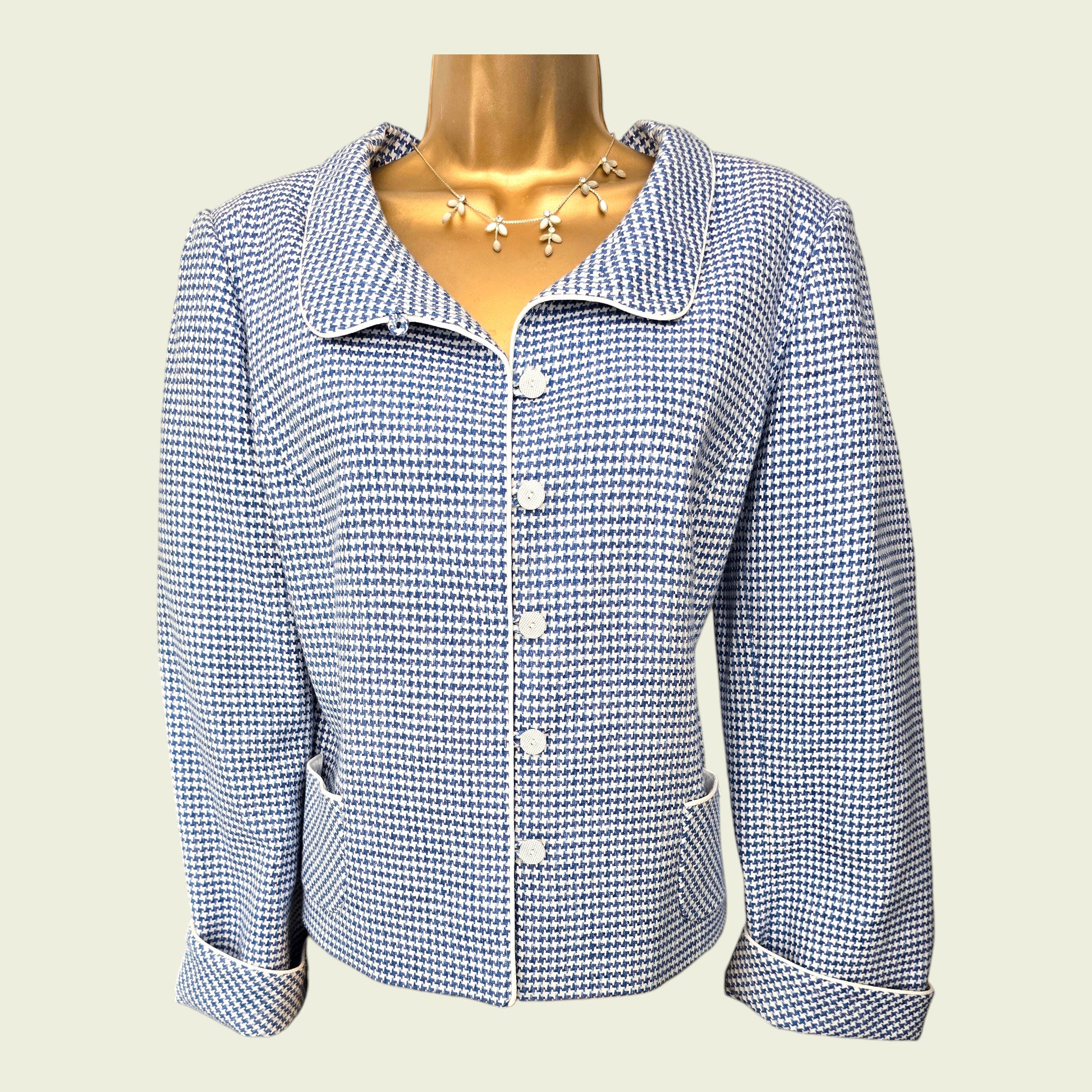 Blue and white checkered jacket on a mannequin against a light background