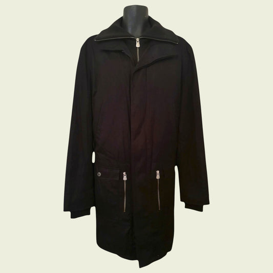 Black coat on a mannequin against a beige background