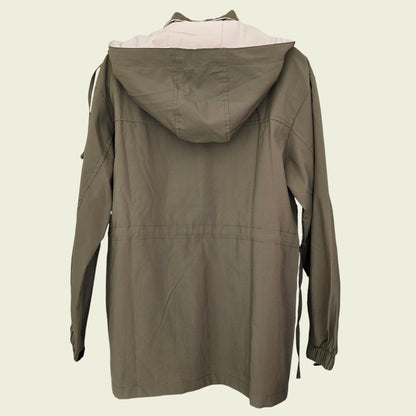 Green hooded jacket on a beige background