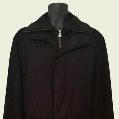 Black coat on a mannequin against a beige background