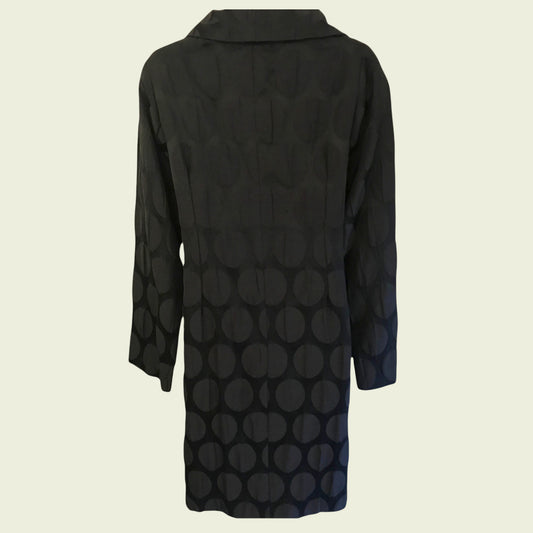 Black coat with geometric pattern on a beige background