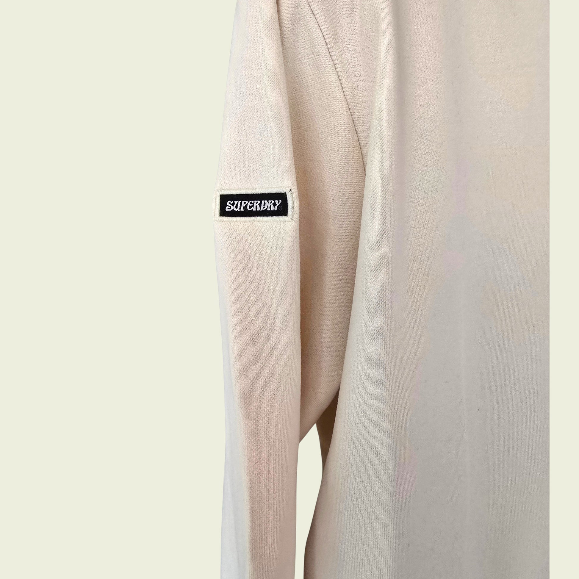 Beige sweatshirt with Superdry logo on a beige background