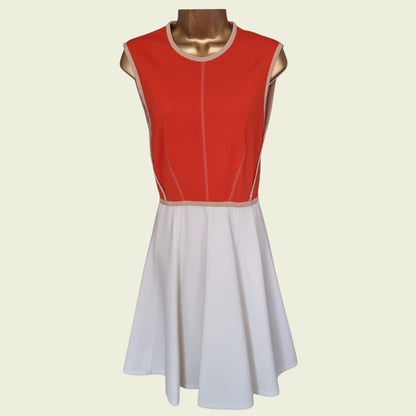 Red and white dress on a mannequin against a beige background