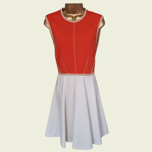 Red and white dress on a mannequin against a beige background