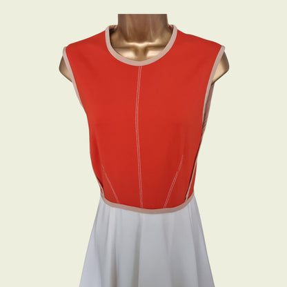 Red sleeveless dress with white trim on a mannequin against a beige background