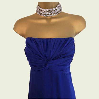 Mannequin wearing a blue strapless dress with a decorative necklace on a beige background