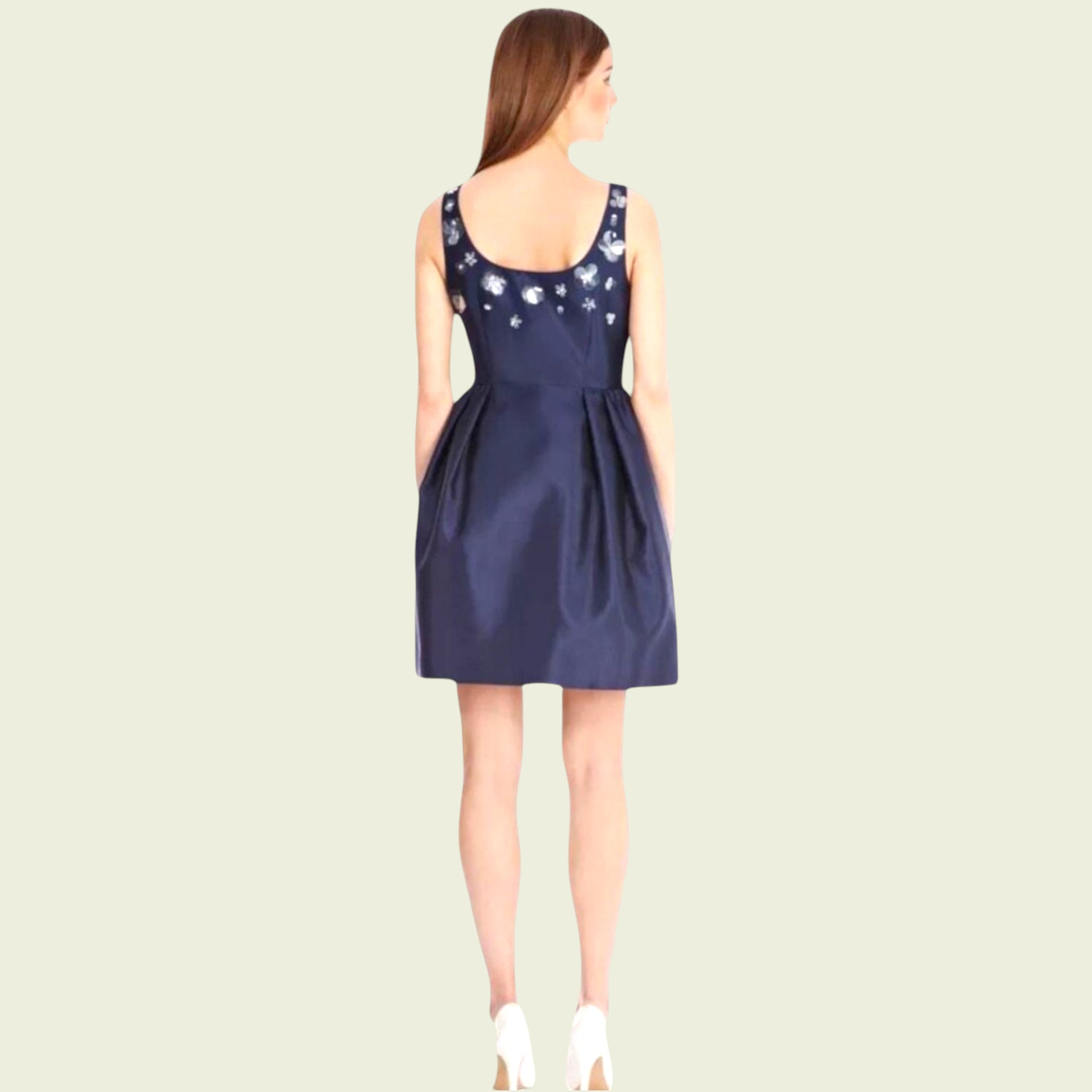 Navy blue dress with floral embellishments on a beige background