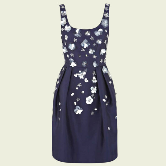 Navy blue dress with white floral pattern on a beige background