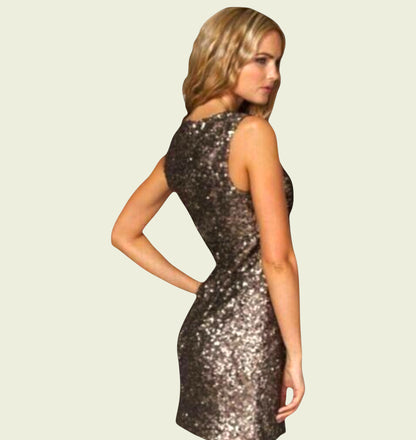 Woman wearing a sequin dress on a plain background