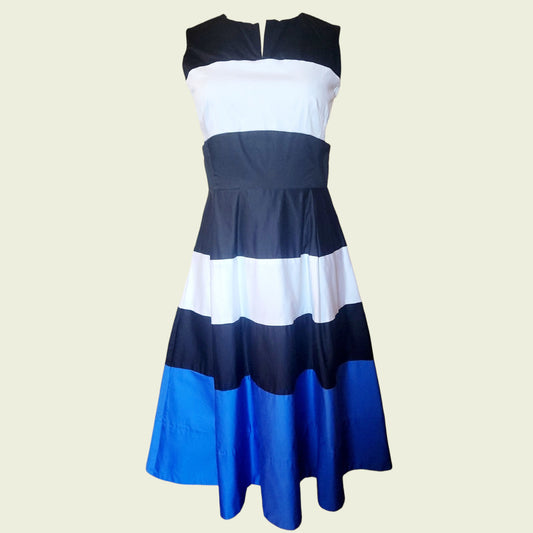 Color-blocked dress with black, white, and blue stripes on a beige background