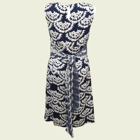 Navy and white patterned strapless dress on a beige background