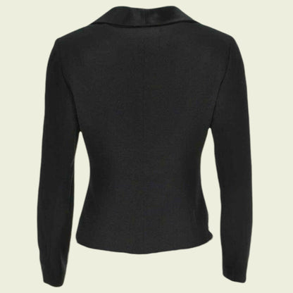 Black long-sleeve top on a beige background