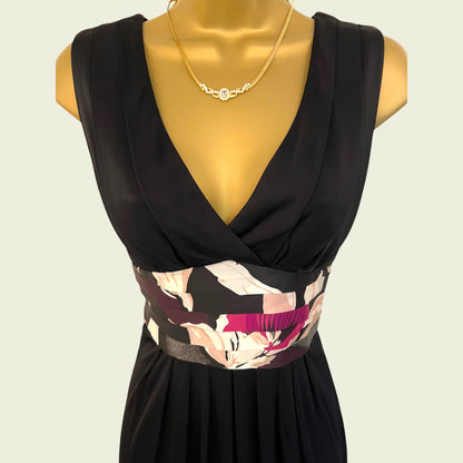 Black dress with floral patterned belt on a mannequin against a beige background