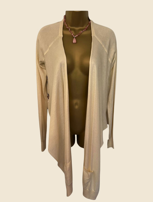 Beige cardigan on mannequin against a beige background