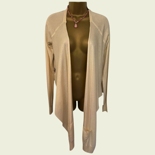 Beige cardigan on a mannequin with a plain background