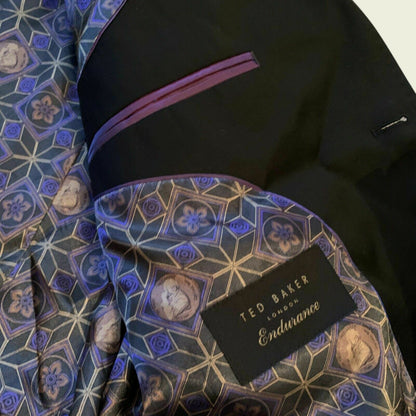 Black suit jacket with a patterned lining and Ted Baker label.