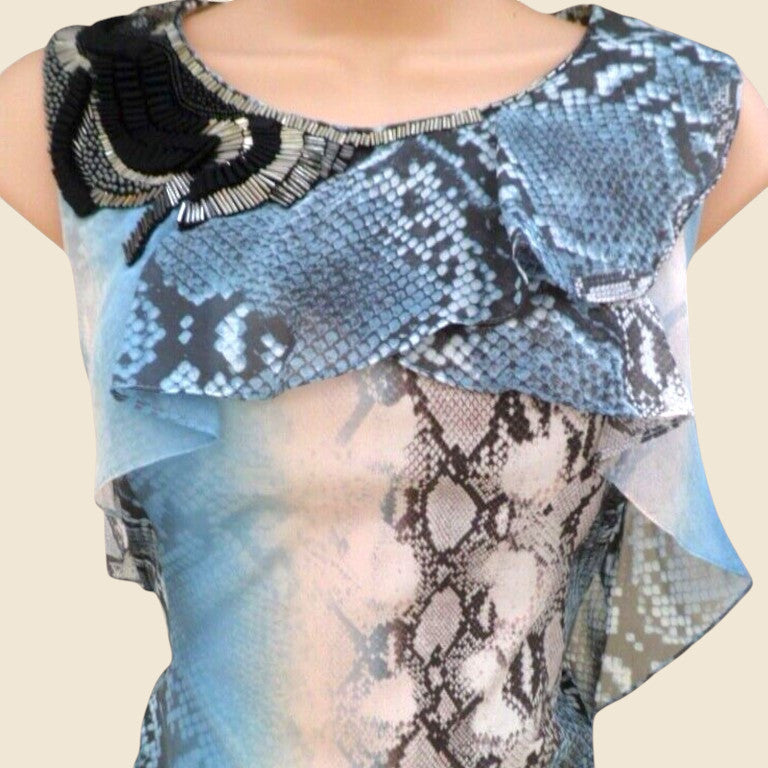 Blue and black patterned top with snake skin design on a beige background