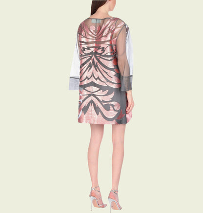 Woman wearing a patterned dress on a light beige background