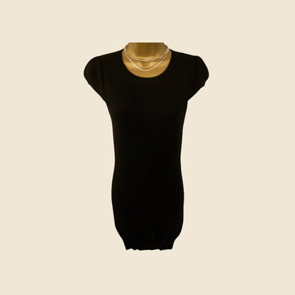 Black dress on a mannequin with a beige background