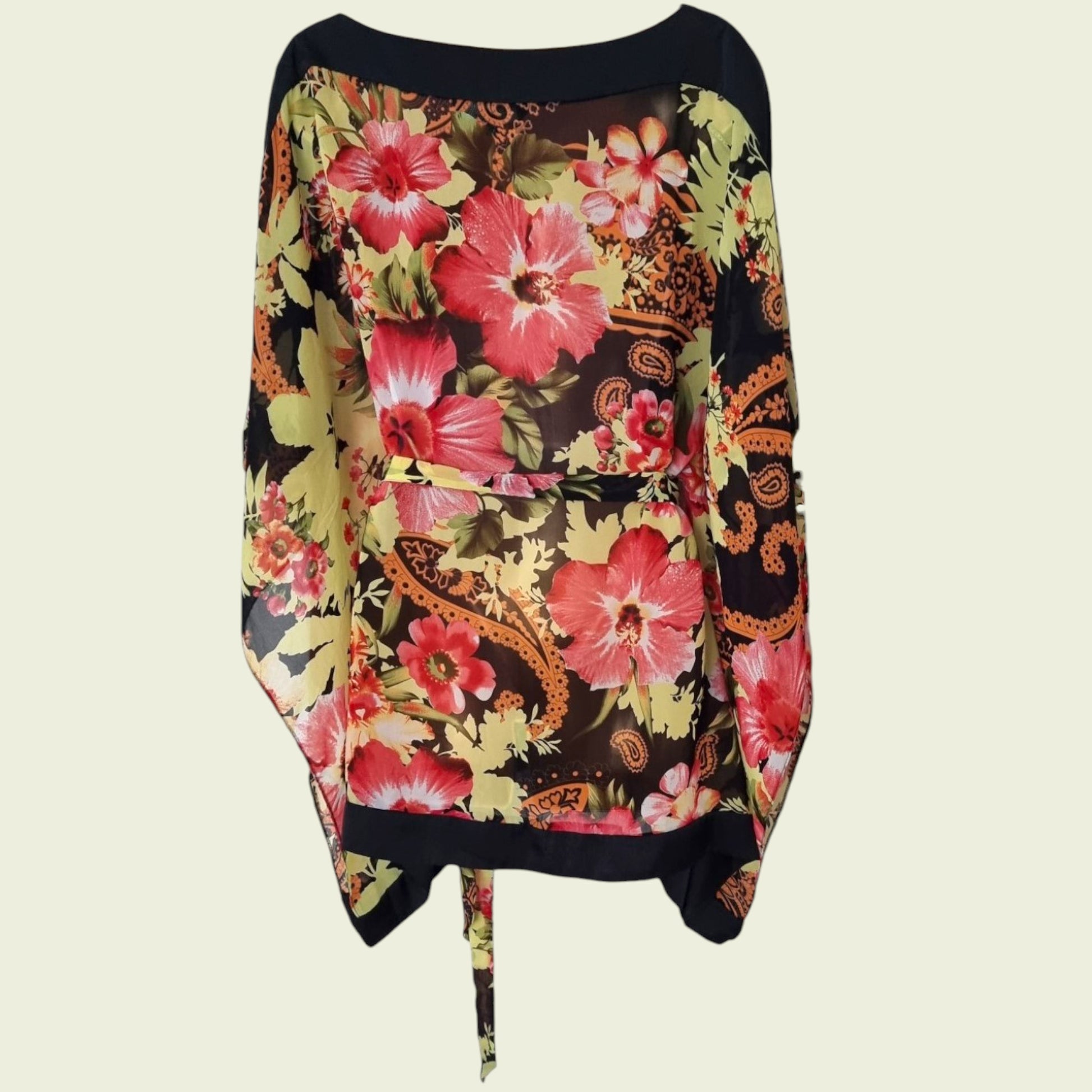 Mannequin wearing floral tunic top on beige background