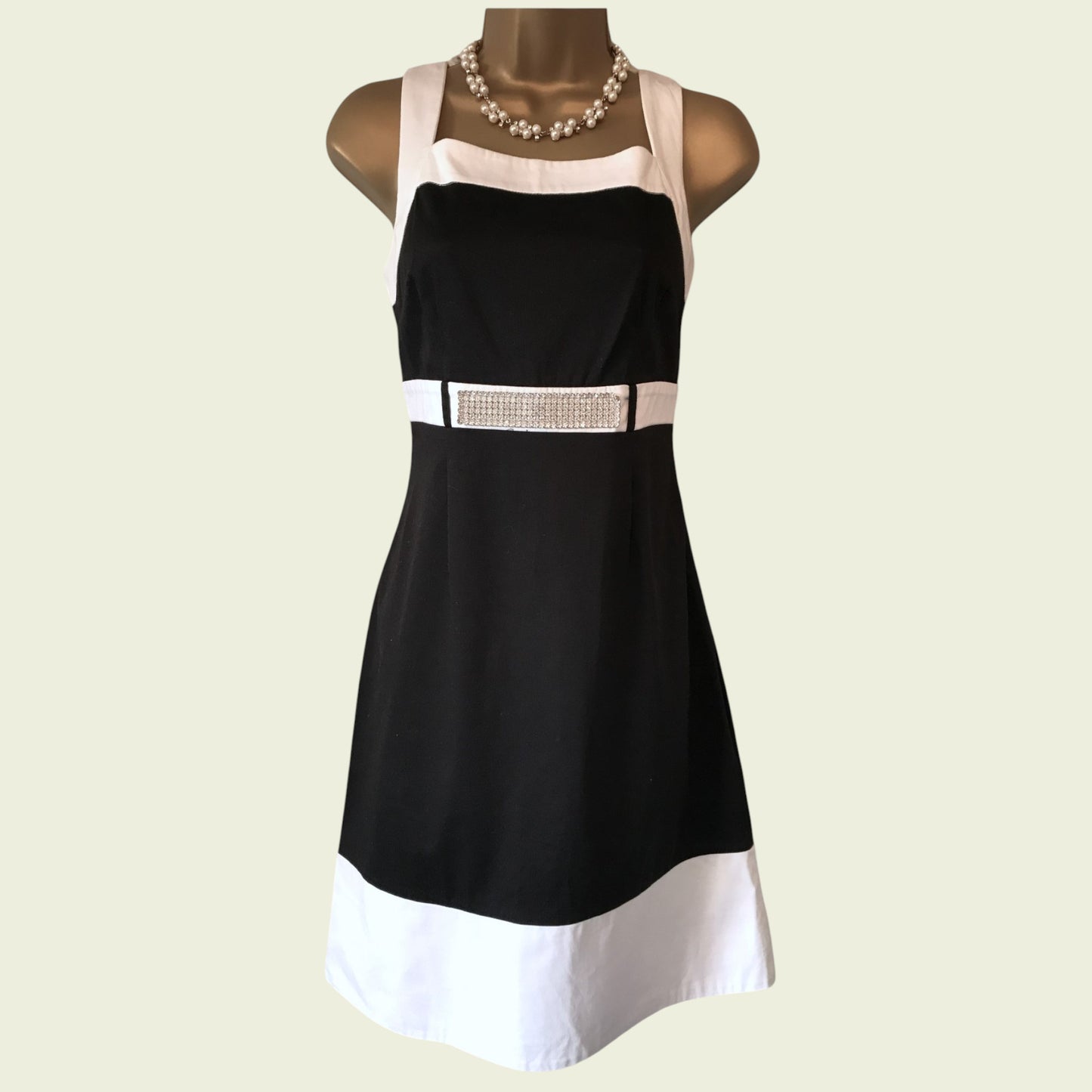 Mannequin wearing black and white dress with diamante detail
